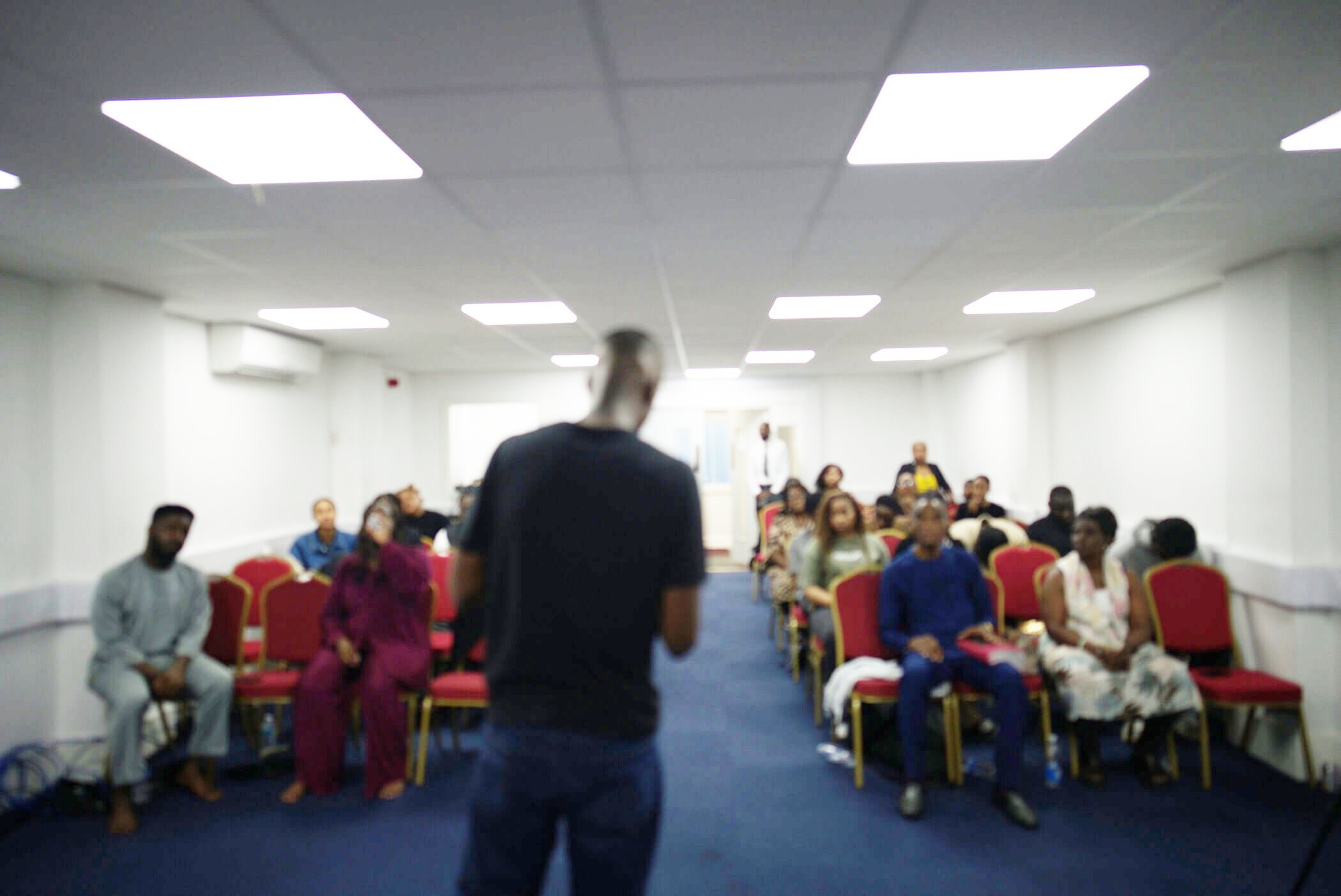 Pastor Sam holding a mic