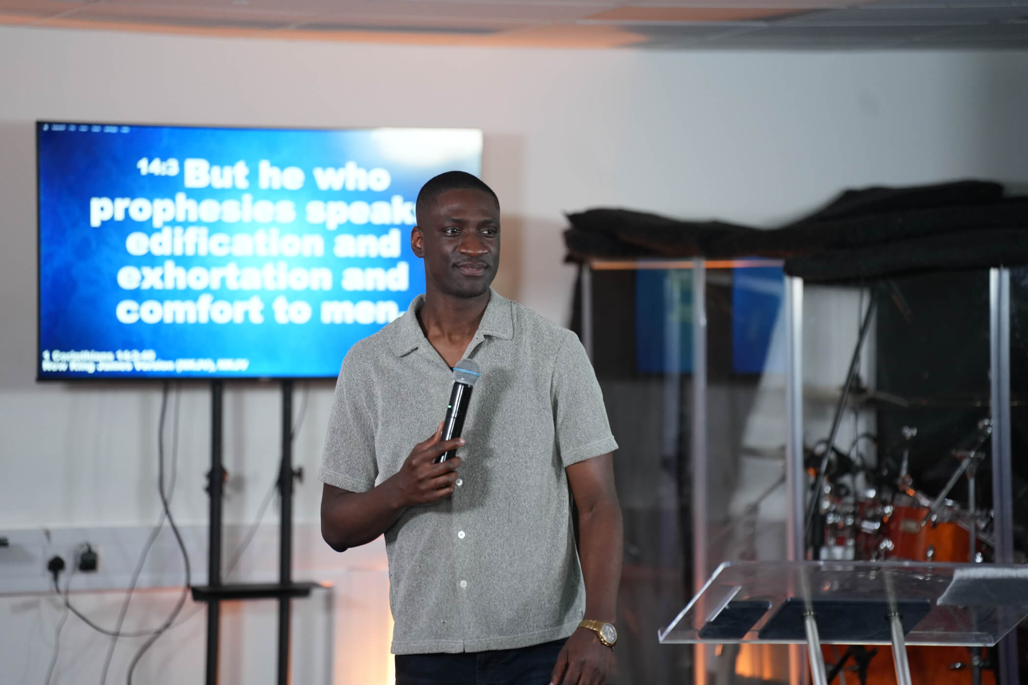 Pastor Sam holding mic